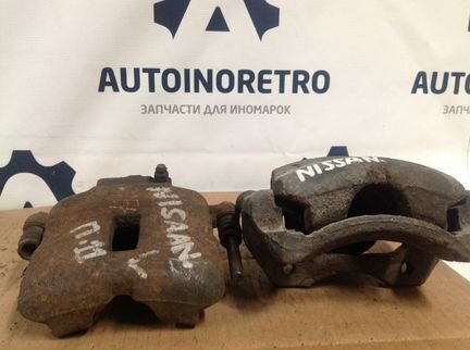 Супорт тормозной передний левый Nissan P11